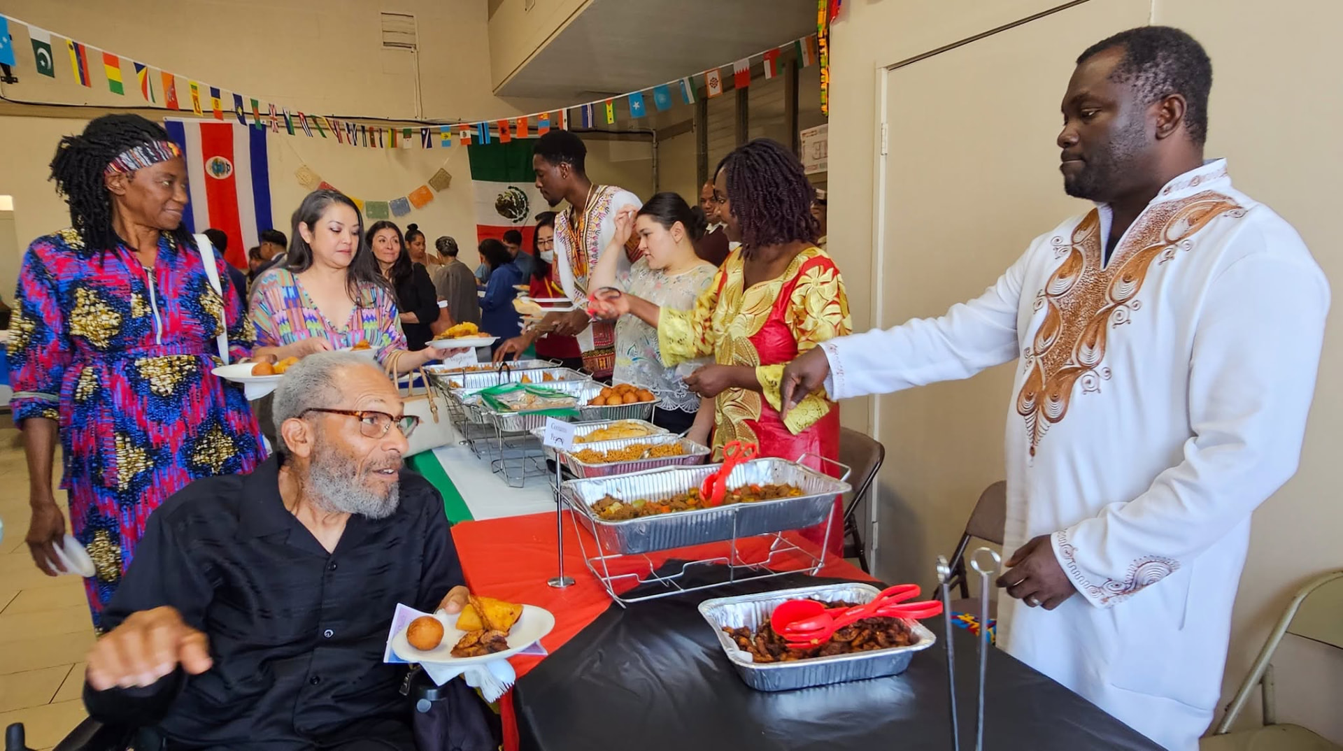 Members and guests of Alhambra Seventh-day Adventist Church sharing dishes from around the world at a church potluck